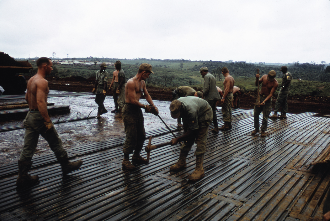 Soldiers working on laying a runway